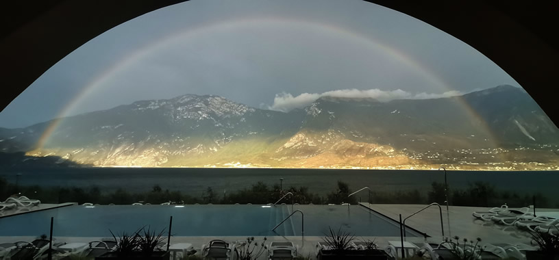 Swimming pool with rainbow in the background